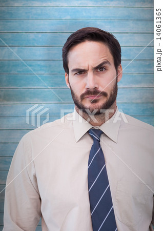 Composite image of portrait of a doubtful young businessman 14061365