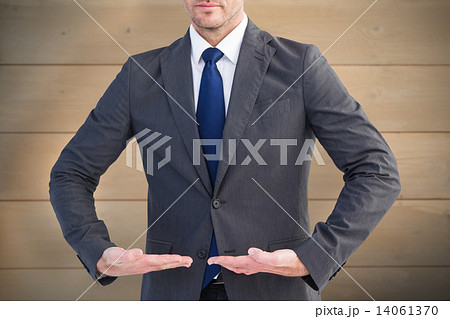 Composite image of businessman presenting your product with hand Composite image of businessman presenting your product with hand 14061370