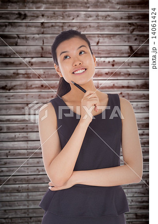 Composite image of thinking businesswoman 14061424