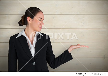 Composite image of happy businesswoman with hand out Composite image of happy businesswoman with hand out 14061726