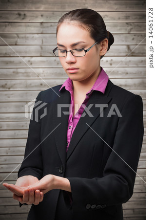 Composite image of businesswomans holding hands out Composite image of businesswomans holding hands out 14061728