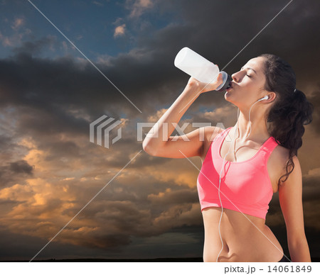 Composite image of beautiful healthy woman drinking water Composite image of beautiful healthy woman drinking water 14061849