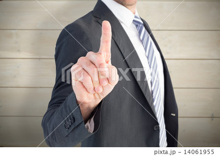 Composite image of businessman pointing with his finger 14061955