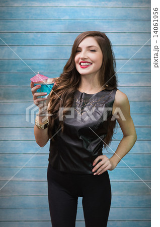 Composite image of brunette with cocktail 14061956