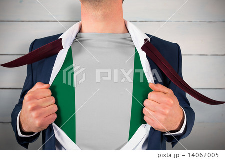 Composite image of businessman opening shirt to reveal nigeria f Composite image of businessman opening shirt to reveal nigeria f 14062005