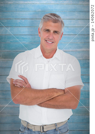 Composite image of casual man smiling at camera 14062072