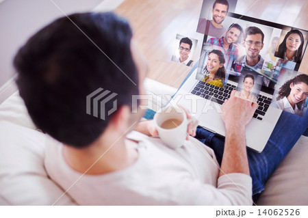 Composite image of high angle view of young man using his laptop Composite image of high angle view of young man using his laptop 14062526