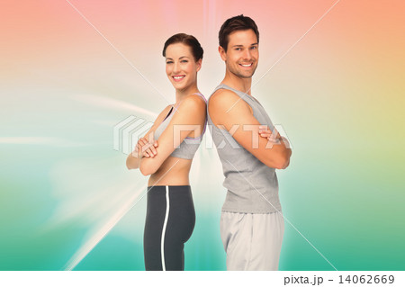 Composite image of portrait of a happy fit young couple with han Composite image of portrait of a happy fit young couple with han 14062669