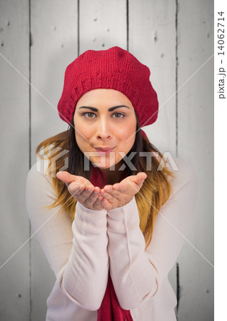 Composite image of brunette in winter clothes with hands out Composite image of brunette in winter clothes with hands out 14062714