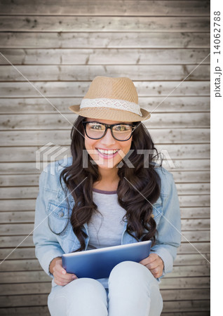 Composite image of brunette with tablet pc Composite image of brunette with tablet pc 14062788
