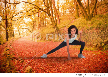 Composite image of fit woman stretching her legs 14062793