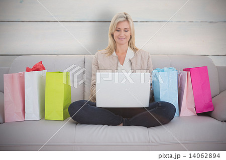 Composite image of woman shopping online Composite image of woman shopping online 14062894