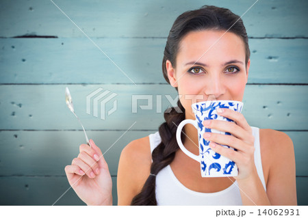 Composite image of pretty brunette having cup of tea Composite image of pretty brunette having cup of tea 14062931