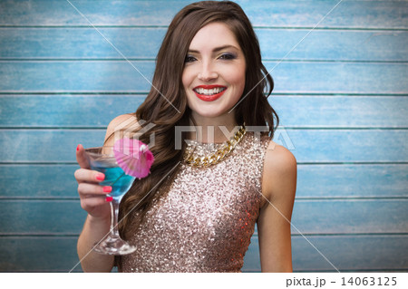 Composite image of brunette with cocktail 14063125