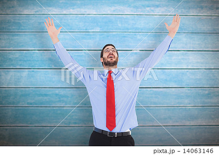 Composite image of happy cheering businessman raising his arms 14063146
