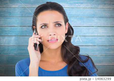 Composite image of pretty brunette talking on the phone 14063299