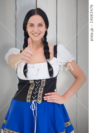 Composite image of pretty oktoberfest girl smiling at camera Composite image of pretty oktoberfest girl smiling at camera 14063476