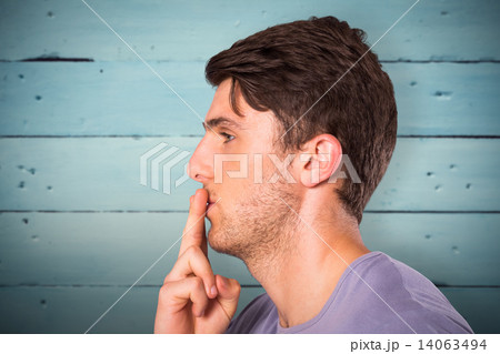 Composite image of young man with finger on lips Composite image of young man with finger on lips 14063494