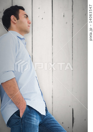 Composite image of unsmiling casual man standing Composite image of unsmiling casual man standing 14063547