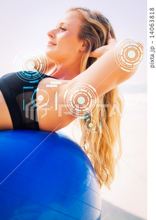 Composite image of fit blonde doing sit ups on exercise ball at Composite image of fit blonde doing sit ups on exercise ball at 14063818