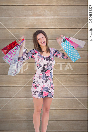 Composite image of woman standing with shopping bag Composite image of woman standing with shopping bag 14063837