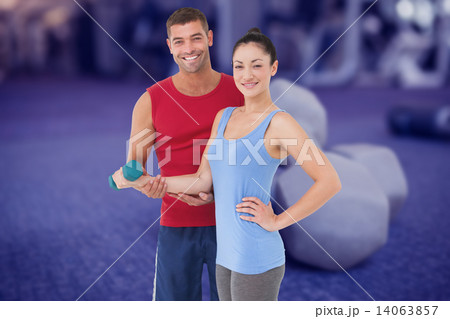Composite image of fit woman and trainer smiling at camera Composite image of fit woman and trainer smiling at camera 14063857