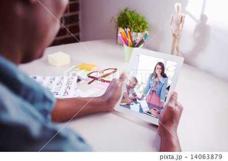 Composite image of photo editor using tablet pc Composite image of photo editor using tablet pc 14063879