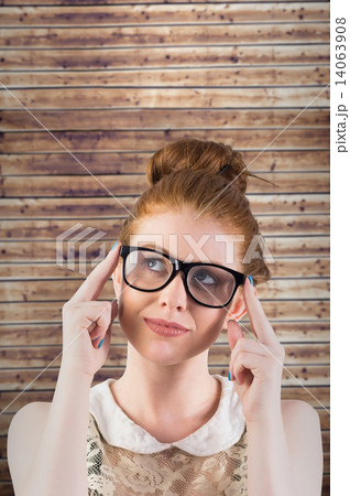 Composite image of hipster redhead looking up thinking Composite image of hipster redhead looking up thinking 14063908