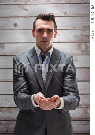 Composite image of businessman presenting with hands Composite image of businessman presenting with hands 14063962