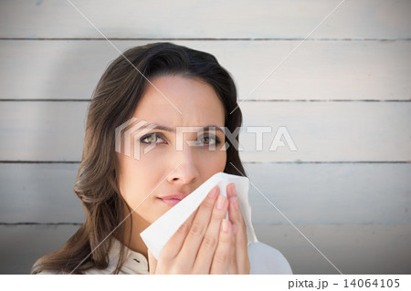 Composite image of brunette with a cold 14064105