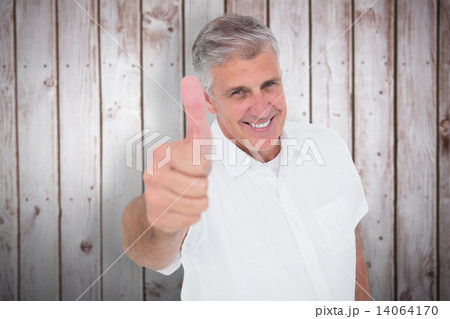 Composite image of casual man showing thumbs up at camera Composite image of casual man showing thumbs up at camera 14064170