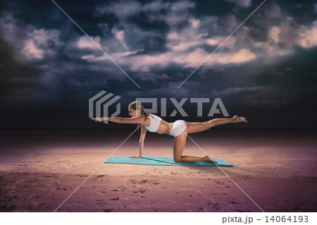 Composite image of gorgeous fit blonde in pilates pose on the be Composite image of gorgeous fit blonde in pilates pose on the be 14064193