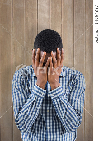 Composite image of young businessman with head in hands 14064337