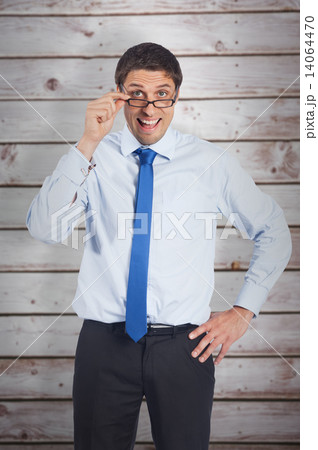 Composite image of thinking businessman tilting glasses Composite image of thinking businessman tilting glasses 14064470