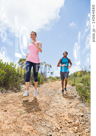 Composite image of fit attractive couple jogging down mountain t 14064660