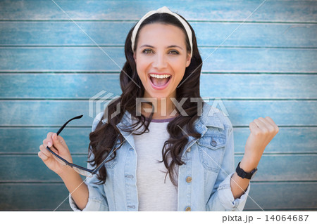 Composite image of cheering brunette 14064687