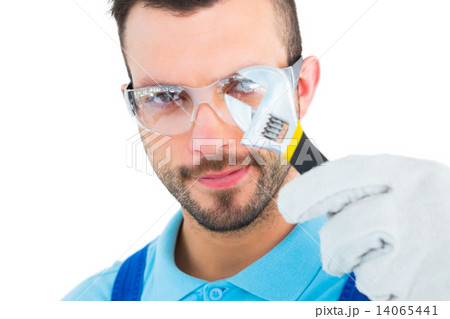 Repairman looking through adjustable wrench Repairman looking through adjustable wrench 14065441