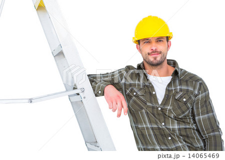 Smiling handyman in overalls leaning on ladder Smiling handyman in overalls leaning on ladder 14065469