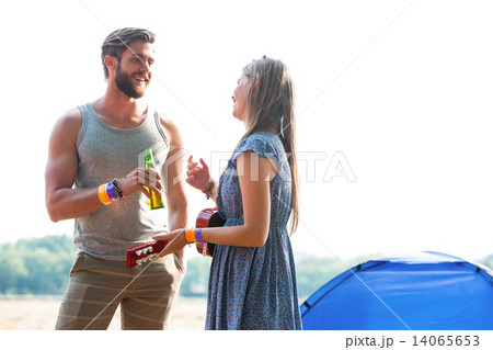 Two friends chatting in campsite Two friends chatting in campsite 14065653