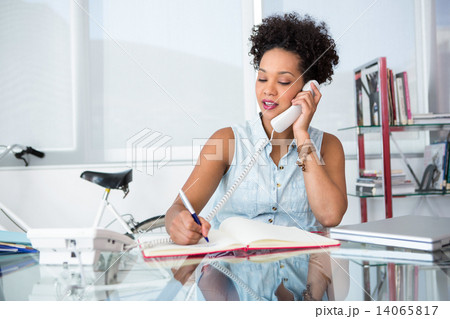 Casual young woman using telephone Casual young woman using telephone 14065817
