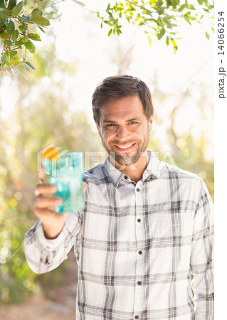 Happy man smiling at camera with drink 14066254