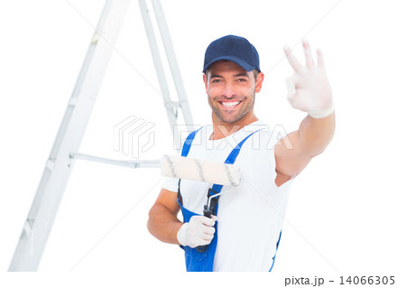 Happy handyman with paint roller gesturing okay Happy handyman with paint roller gesturing okay 14066305