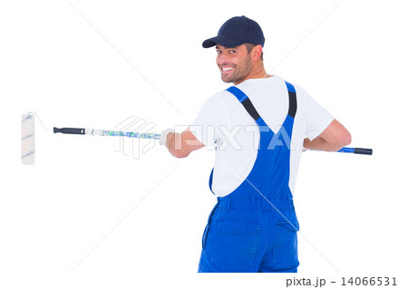 Handyman in overalls using paint roller on white background Handyman in overalls using paint roller on white background 14066531