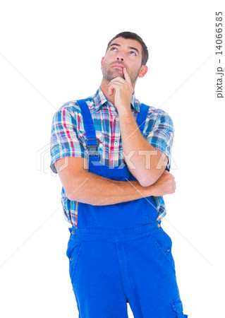 Thoughtful handyman in coveralls looking up Thoughtful handyman in coveralls looking up 14066585