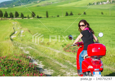 Young woman traveling by a scooter 14070297