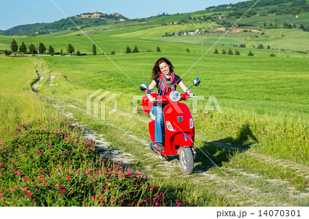 Young woman traveling by a scooter Young woman traveling by a scooter 14070301