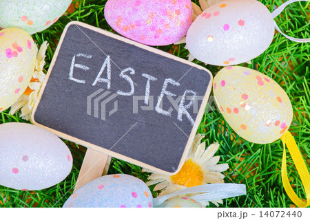 Easter eggs with chalkboard on the grass 14072440