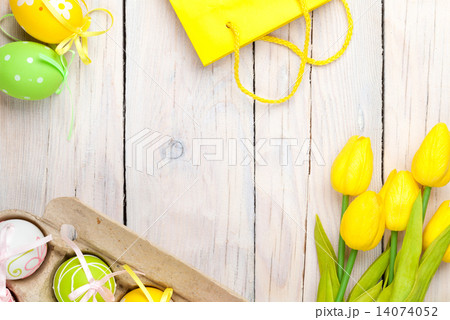 Easter background with colorful eggs and yellow tulips Easter background with colorful eggs and yellow tulips 14074052