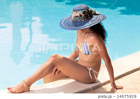 Woman With Blue Hat Tanning In The Swimming Pool Woman With Blue Hat Tanning In The Swimming Pool 14075929