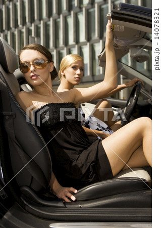 two pretty woman in black car 14078321